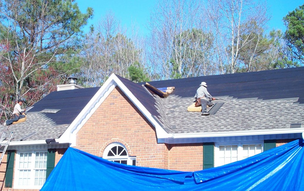 roofers replacing a roof